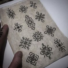 a person is holding up a piece of paper with chinese writing on it