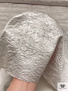 a person's hand is wrapped in silver foil