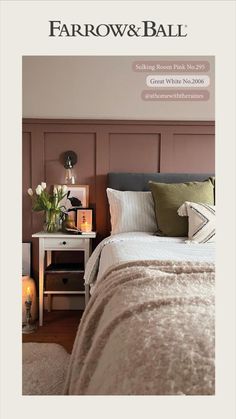 a bed with blue and green pillows on top of it next to a window in a bedroom