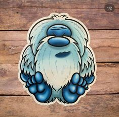 a blue and white sticker with an image of a bigfoot on it's face