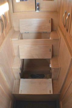 the inside of a small wooden cabin with drawers