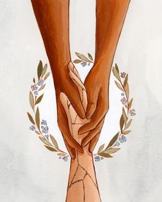 two hands holding each other over a floral wreath