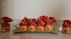 there are some bread buns with red bows on them and other decorations in the shape of heads