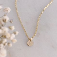 A dainty little 14k Gold Filled initial disc is hand stamped with your choice of initial in uppercase block font. The disc measures 8mm (1/4").  The initial disc comes on a delicate, but very strong, 14k Gold Filled chain.Beautifully packaged in our signature white and gold Eden Zoe gift box. Block Font, Gold Filled Chain, Initial Necklace, Hand Stamped, Eden, Gold Filled, New Zealand, Initials, Gold Necklace