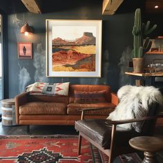 a living room with two couches and a painting on the wall above them,