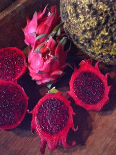 the dragon fruit is cut in half and ready to be picked from the bushel