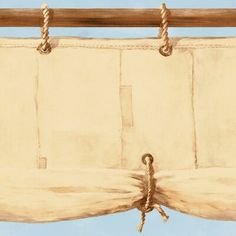 an old curtain with rope hanging from it's end on a blue sky background