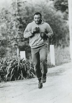 a black and white photo of a man running