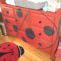 a ladybug painted on the side of a dresser in a child's bedroom