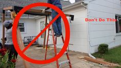 a man standing on a ladder in front of a house with a sign that says don't do this