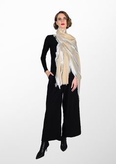 Woven from a luxurious wool and silk blend, this beige scarf offers both style and warmth. The stunning feature of this scarf is the contrasting white fringe detailing meticulously handcrafted across the length of the scarf as panels creating an eye-turning statement piece. Embrace the allure of this exquisite creation, an authentic embodiment of craft and contemporary fashion. Luxury White Silk Shawl, Luxury Beige Wool Shawl, Luxury Beige Silk Shawl, Luxury Beige Silk Scarf, White Fringe Scarf, White Fringe Shawl, Beige Scarf, White Fringe, Contemporary Fashion