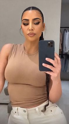 an image of a woman taking a selfie with her cell phone in the mirror