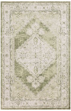 a green and white rug with an ornate design