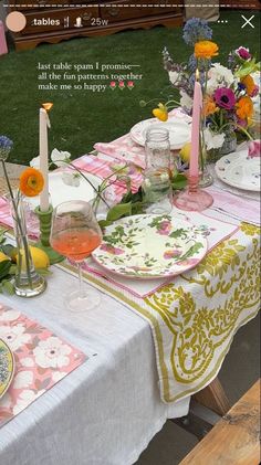 a table set with plates and flowers on it for an outdoor dinner party or brunch