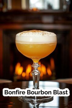 a glass filled with liquid sitting on top of a table next to a fire place