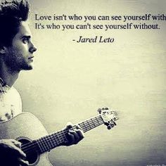 a man holding an acoustic guitar with a quote on the back ground that says, love isn't who you can see yourself with it