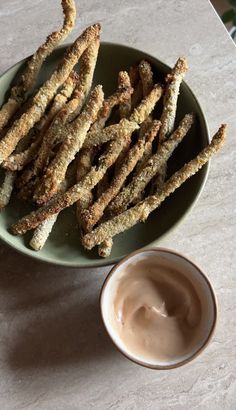 some fried food on a green plate with dipping sauce