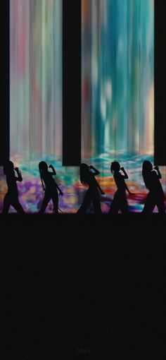 the silhouettes of people are walking in front of an abstract background with multicolored lights