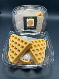 two waffles in a plastic container on a table