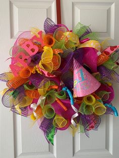 a colorful birthday wreath on the front door