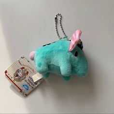 a stuffed animal keychain with a tag attached to it