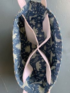 a blue and white plate with an animal design on the side, hanging from a hook