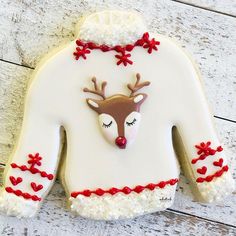 a decorated cookie shaped like a sweater and reindeer's head