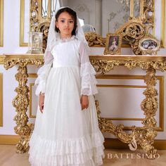 Traditional Catholic First Communion Dress and Veil Handcrafted  100% Cotton  Italian Lace When it comes to selecting the perfect First Communion dress, nothing compares to the exquisite beauty of Italian Lace. This timeless fabric adds an elegant touch to any 1st Communion dress, making it a cherished keepsake for years to come. Italian Lace is renowned for its intricate patterns and delicate craftsmanship. Each dress is carefully crafted with attention to detail, ensuring that every stitch is flawless. The result is a First Holy Communion dress that exudes grace and sophistication. Not only does Italian Lace create a stunning aesthetic, but it also symbolizes the significance of this sacred occasion. The purity and innocence represented by the First Communion are beautifully reflected in Long Sleeve Ruffled Dress For First Communion, Elegant Long Sleeve Dress For First Communion, Fitted Gown For Confirmation With Long Sleeves, Fitted Long Sleeve Gown For Confirmation, Elegant Long Sleeve Confirmation Dress, Fitted Ruffled Dress For Confirmation, Fitted Ruffle Dress For Confirmation, Long Sleeve Confirmation Dress With Lace Trim, White Long Sleeve Confirmation Dress