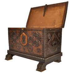 an old wooden chest with carvings on the front and sides, sitting against a white background