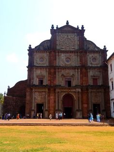 an old church with people walking around it