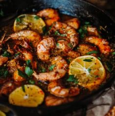 shrimp with lemons and herbs in a skillet