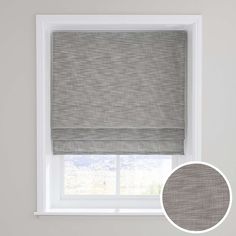 a grey roman blind in front of a window