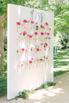 a large white sign with flowers on it