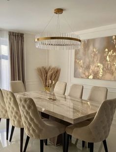 a dining room table with chairs and a chandelier