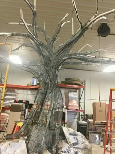 a tree that is in the middle of some kind of work area with lots of wires on it