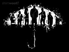 a group of people standing in front of a black and white background with paint splatters