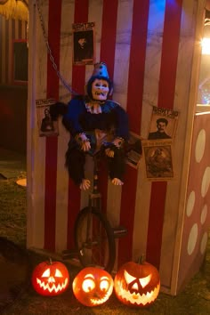 two jack o lantern pumpkins and a clown on a bike