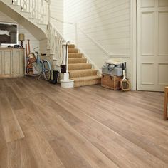 a wooden floor with stairs leading up to it