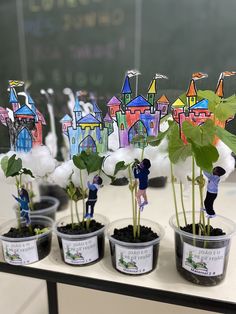 several potted plants with miniature people on them