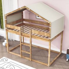 a child's bed with a wooden frame and mattress in the shape of a house