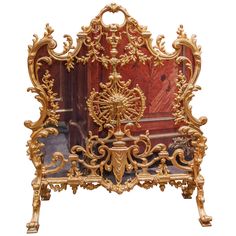 an ornately decorated gold and red bed frame