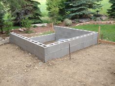 a cinder block wall in the middle of a yard