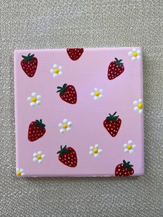 a pink square with strawberries and daisies on it, painted in acrylic