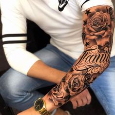 a man with a rose tattoo on his arm is sitting in front of the camera