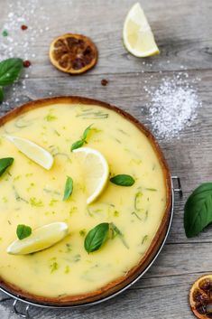 a pie with lemons and basil on top