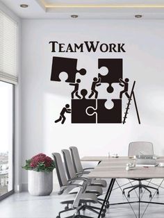 a wall decal with the words team work and puzzle pieces in black on it