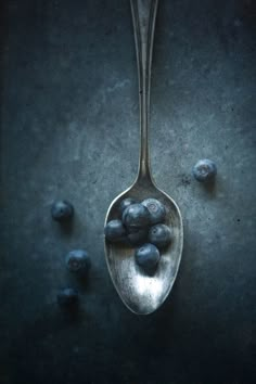 a spoon with some blueberries on it