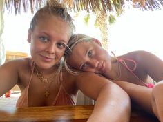 two young women are posing for the camera