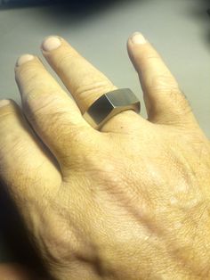 a person's hand with a ring on it