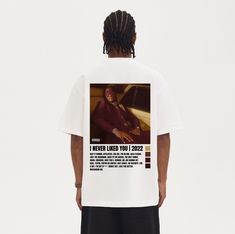 a man with dreadlocks standing in front of a white t - shirt that reads, 22 / 29 you lead your own